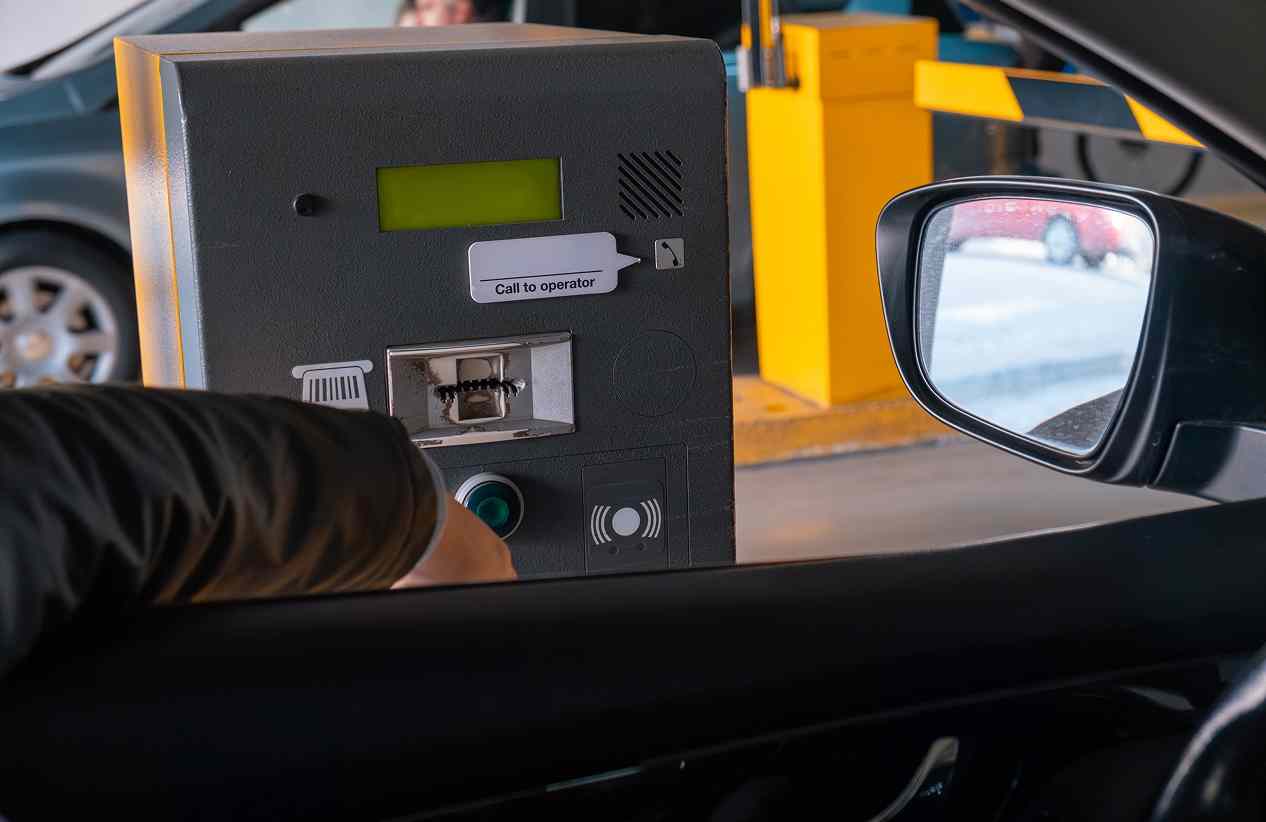 person using a call box leaving a parking garage