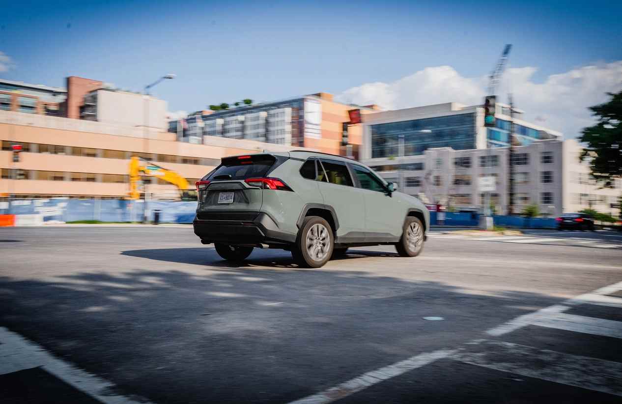 SUV driving through an intersection on a sunny day