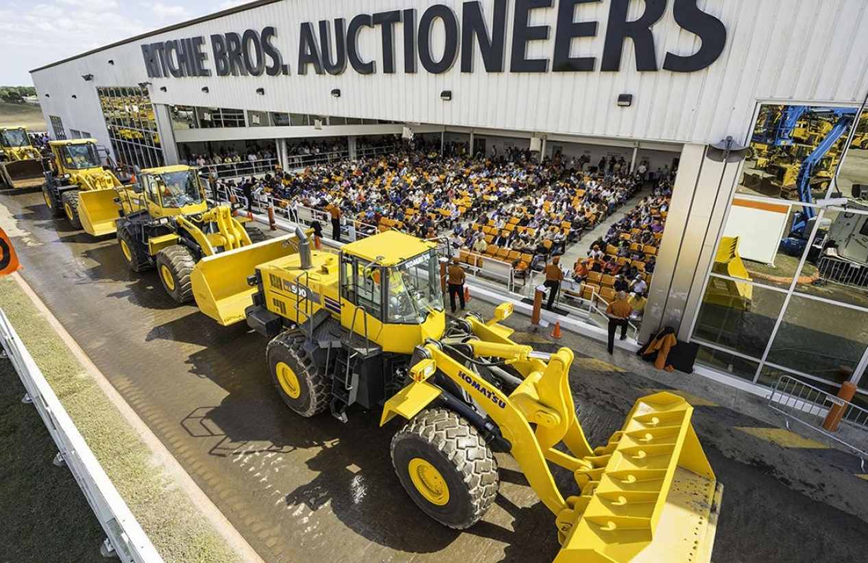 exterior view of Ritchie Bros Auctioneer with tractors parked in front of the building
