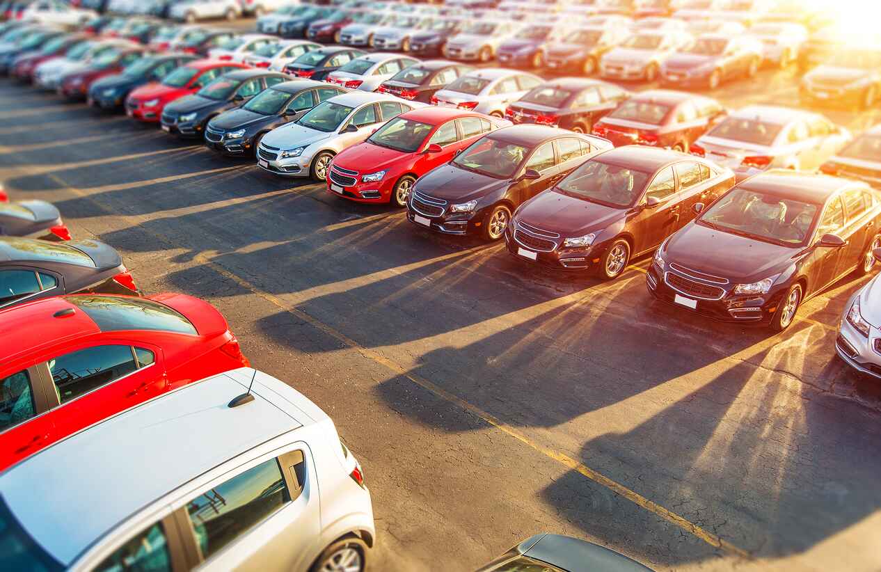 parking lot full of vehicles at sunset