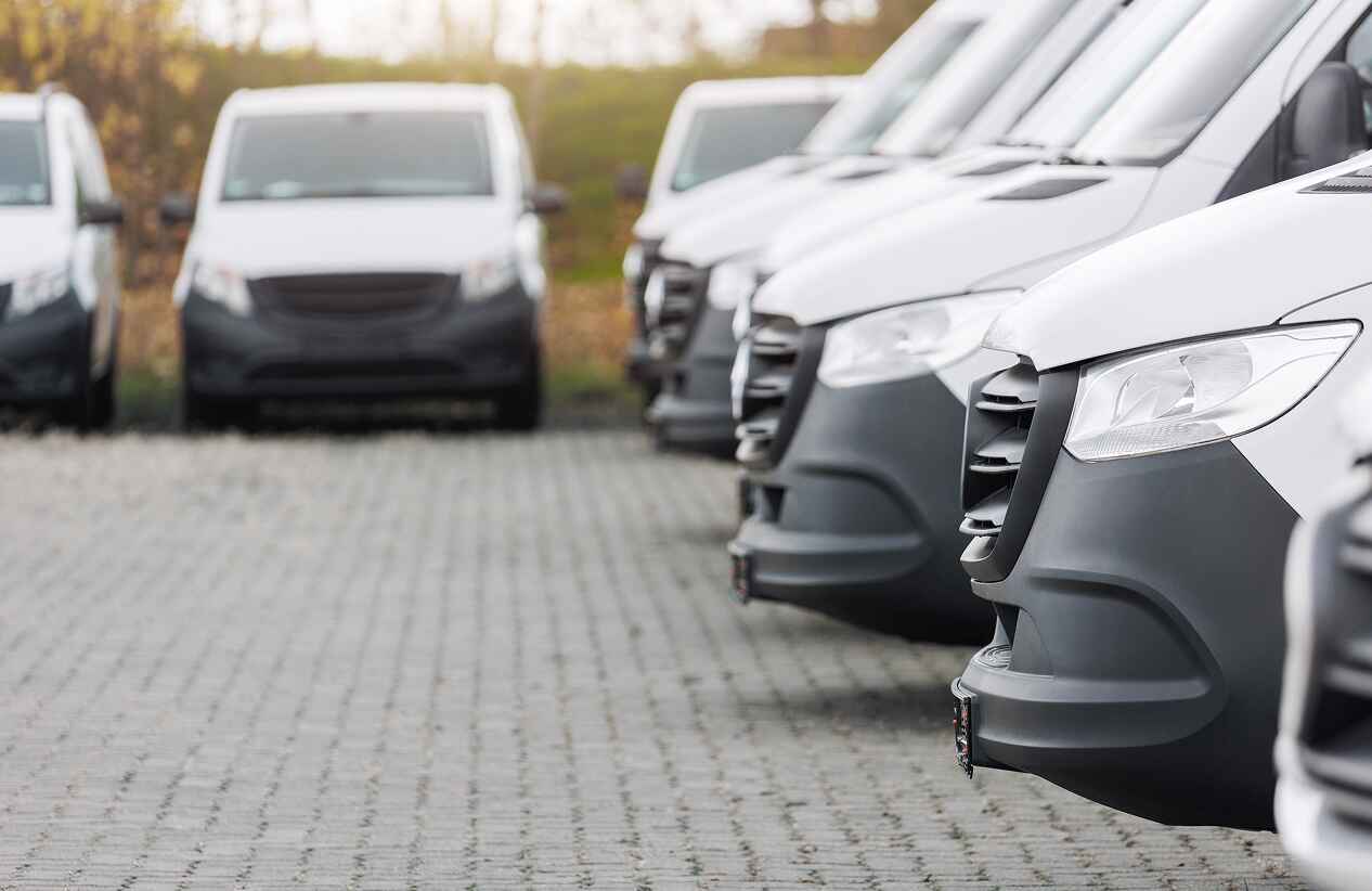 fleet of sprinter vans parked in a lot