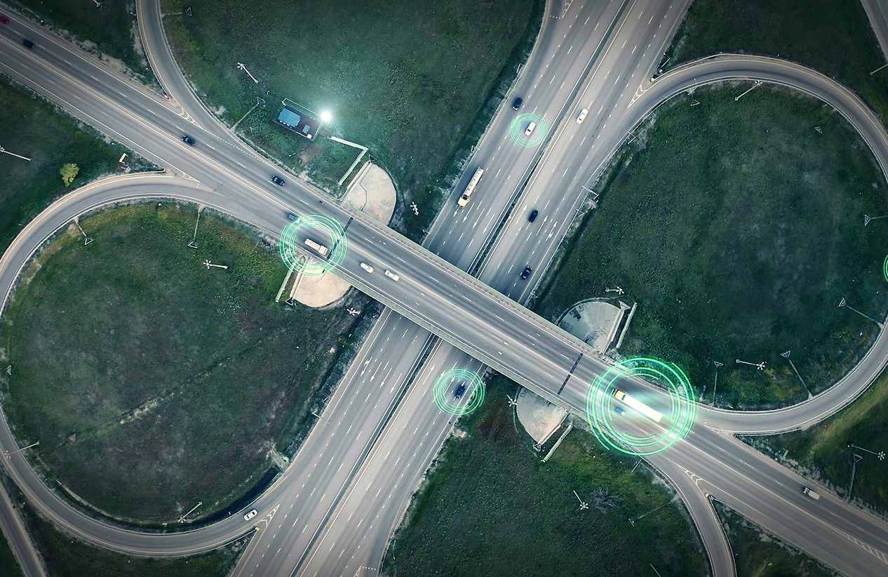 aerial view of circular interstate on and off ramps with cars highlighted in circles