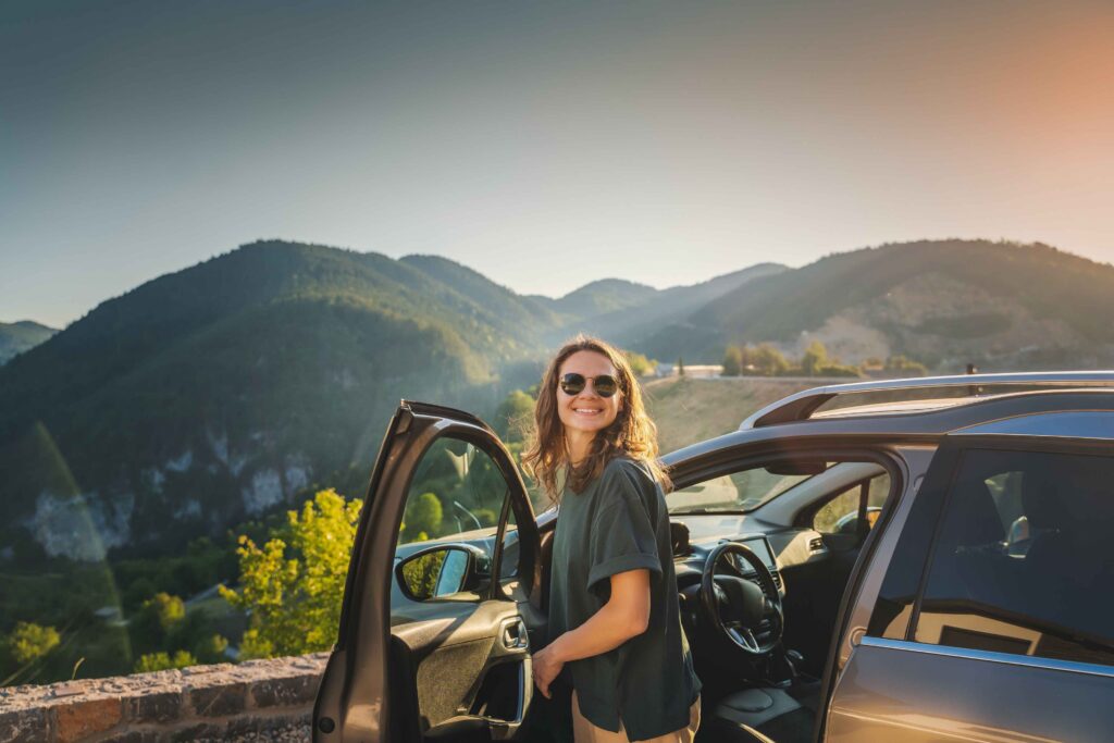 women exiting car parked at overlook