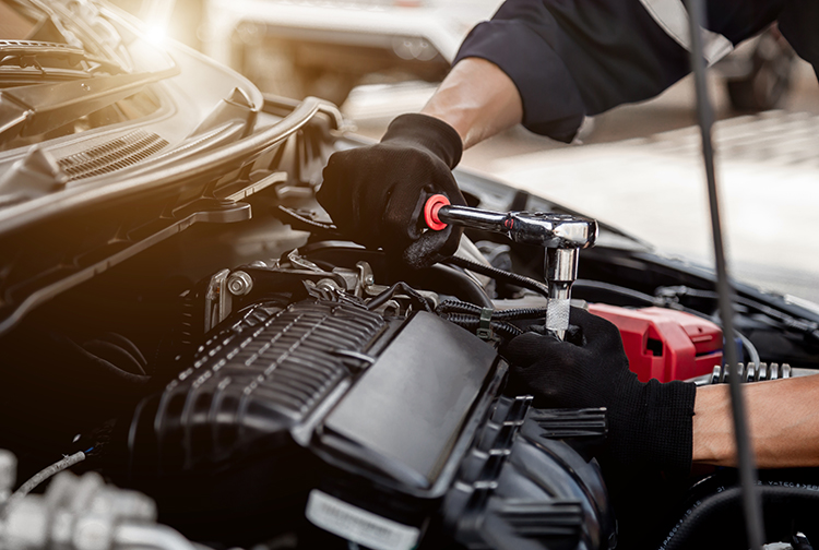 Car care maintenance and servicing, Close-up hand technician auto mechanic using a wrench. 
