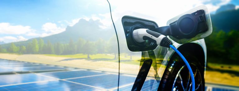 EV charging station for electric car in concept of green energy and eco power produced from sustainable source to supply to charger station in order to reduce CO2 emission .