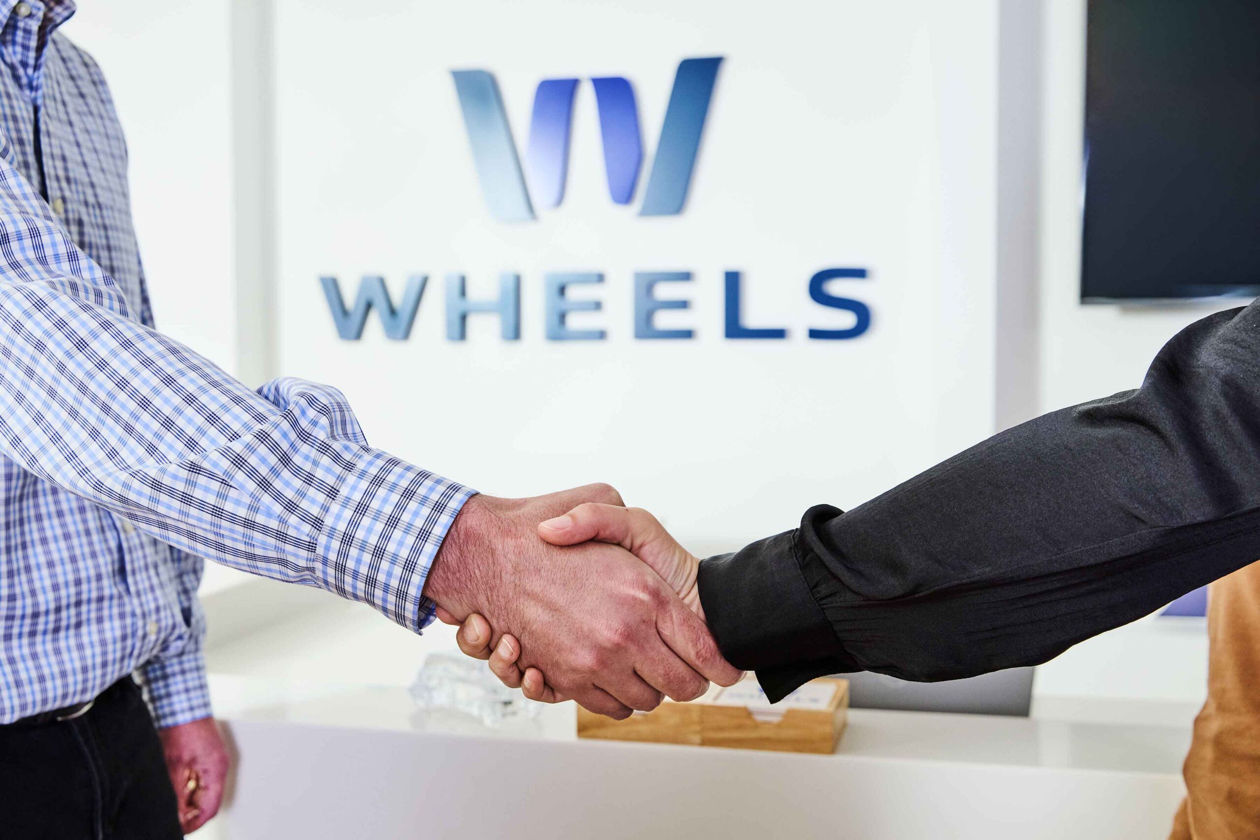Wheels employee and customer shaking hands