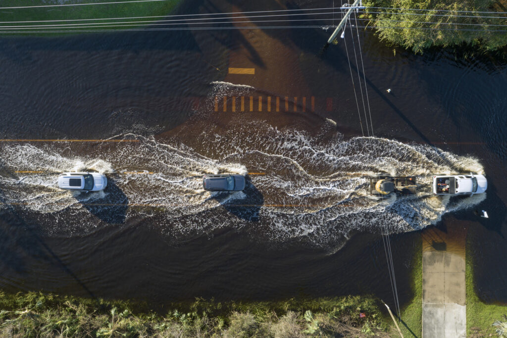cars driving through flooded road