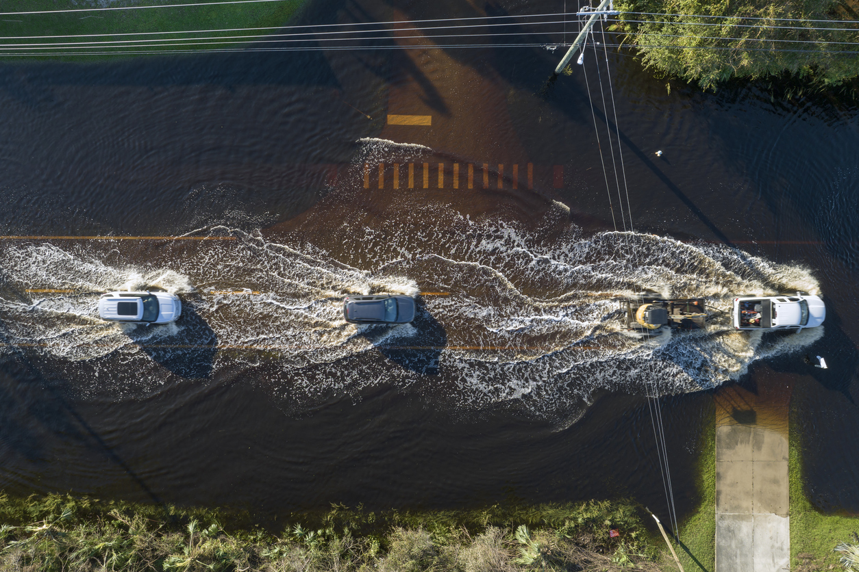 cars driving through flooded road