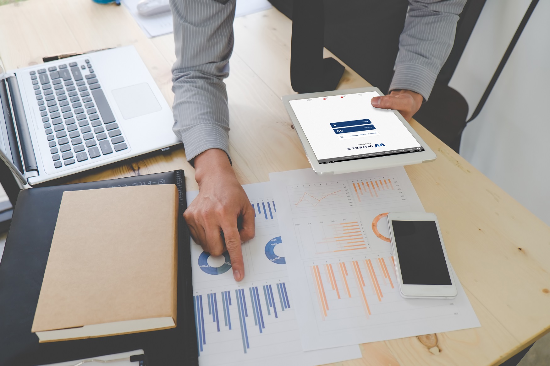 Image of man looking charts and graphs