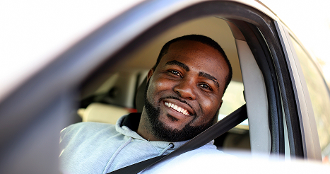 Young man driving a car. About 30 years old, African male.