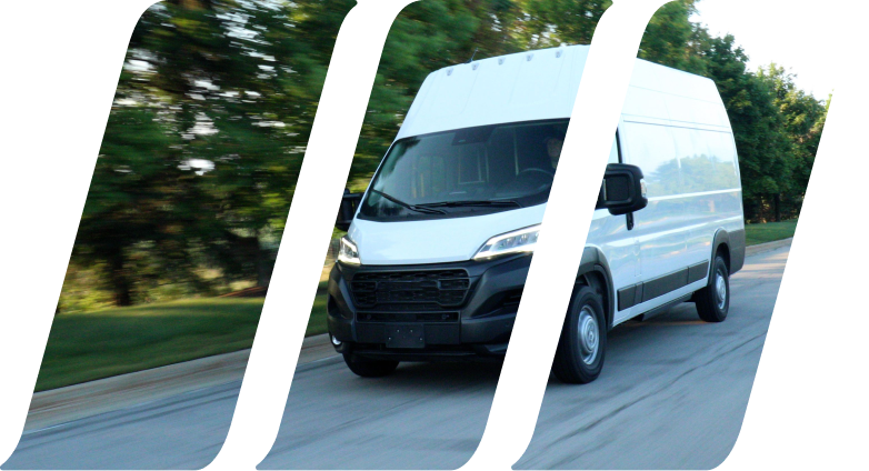 white cargo van driving down road