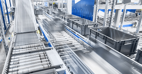 Modern conveyor system with boxes in motion, shallow depth of field.