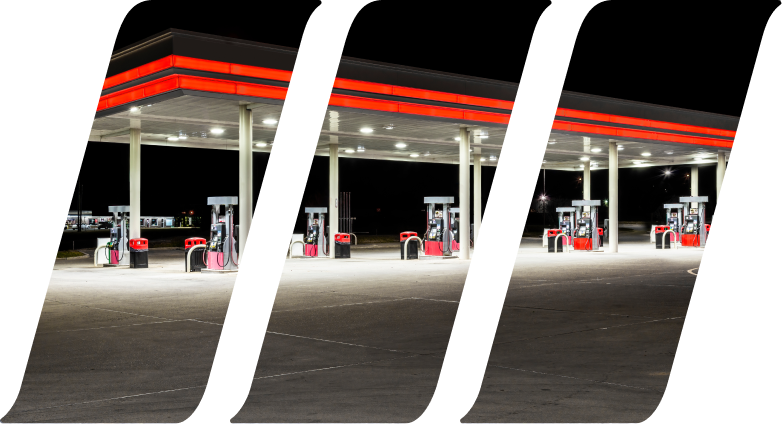 Horizontal shot of a generic unbranded gas station at night.