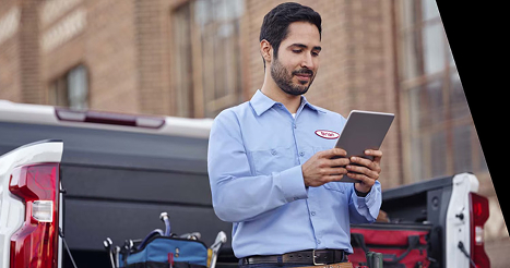 man in blue shirt holding tablet