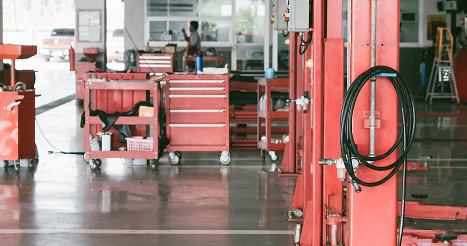 Empty car service garage with mechanical tools (selective focus)