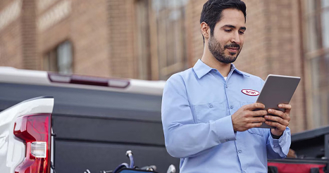 Man Using Tablet Looking at Vehicle Data