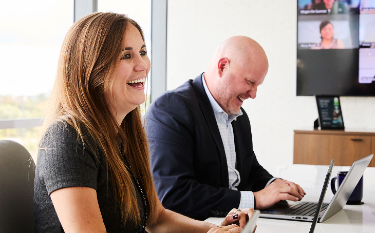 Wheels employee laughing in group meeting