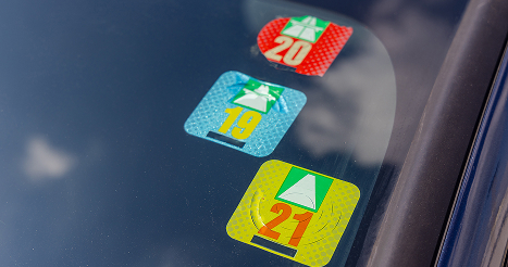 windshield showing parking stickers