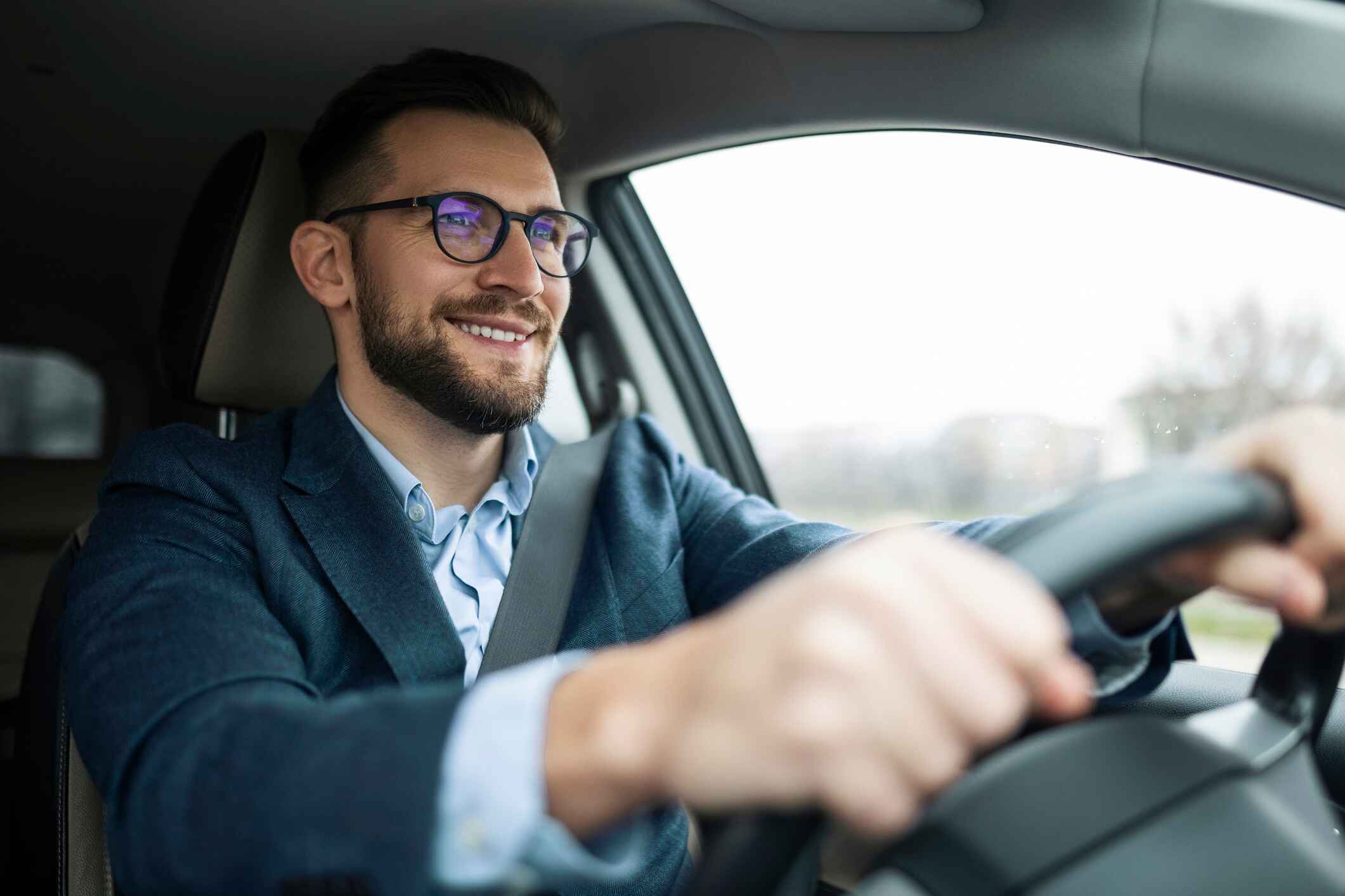 man driving car while smiling