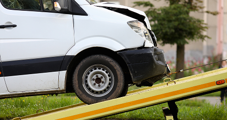 Crashed car is immersed in tow truck closeup. Car evacuation after an accident concept