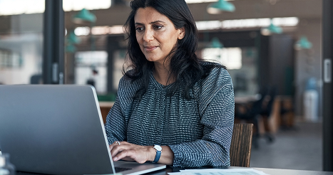 woman working at her desk on a laptop computer