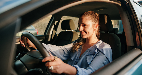 women smiling while driving car