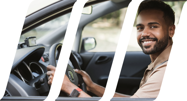 adult driver sitting in his car and smiling while looking out the window