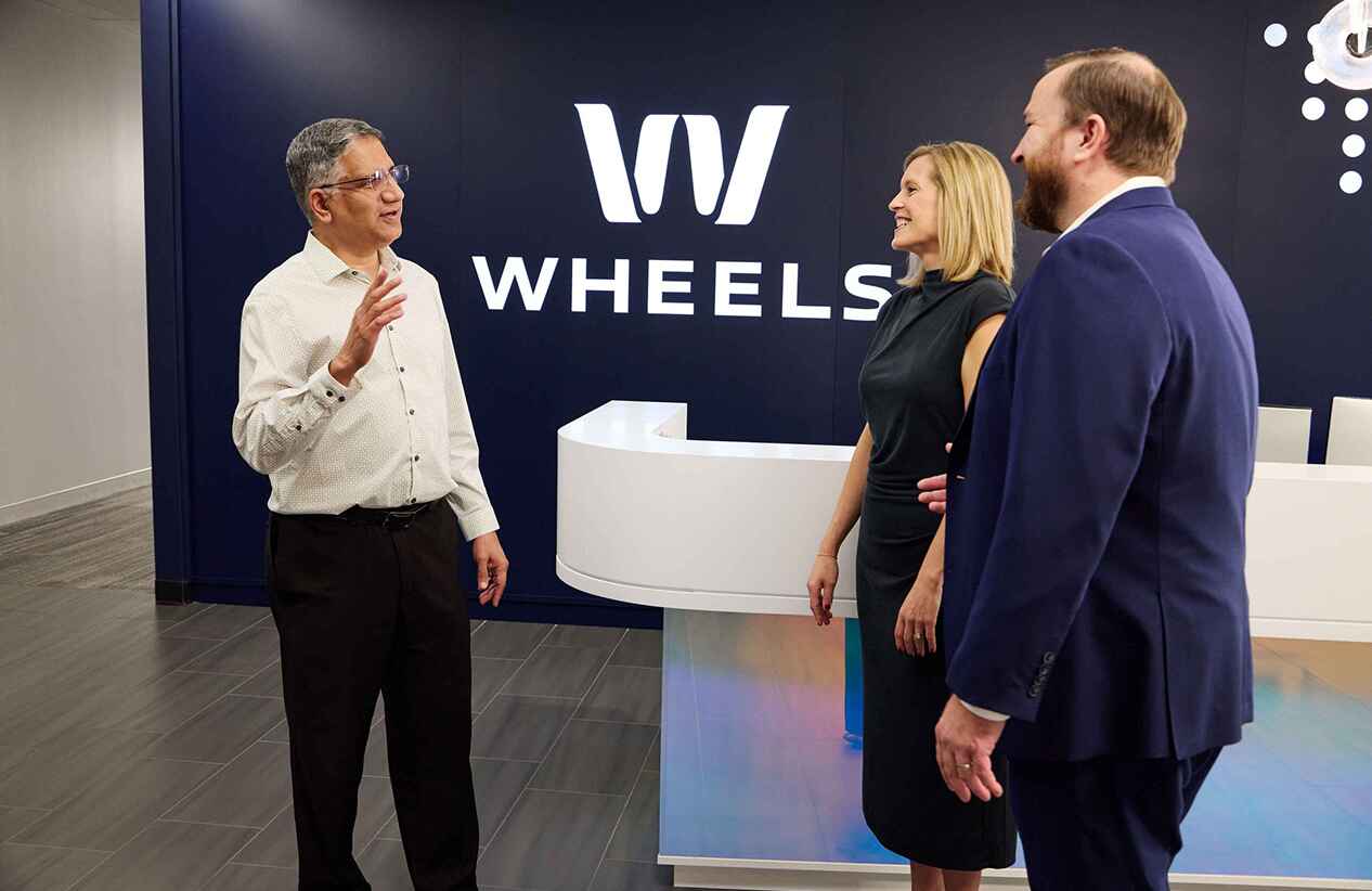 Wheels employees having a conversation in the Wheels office lobby